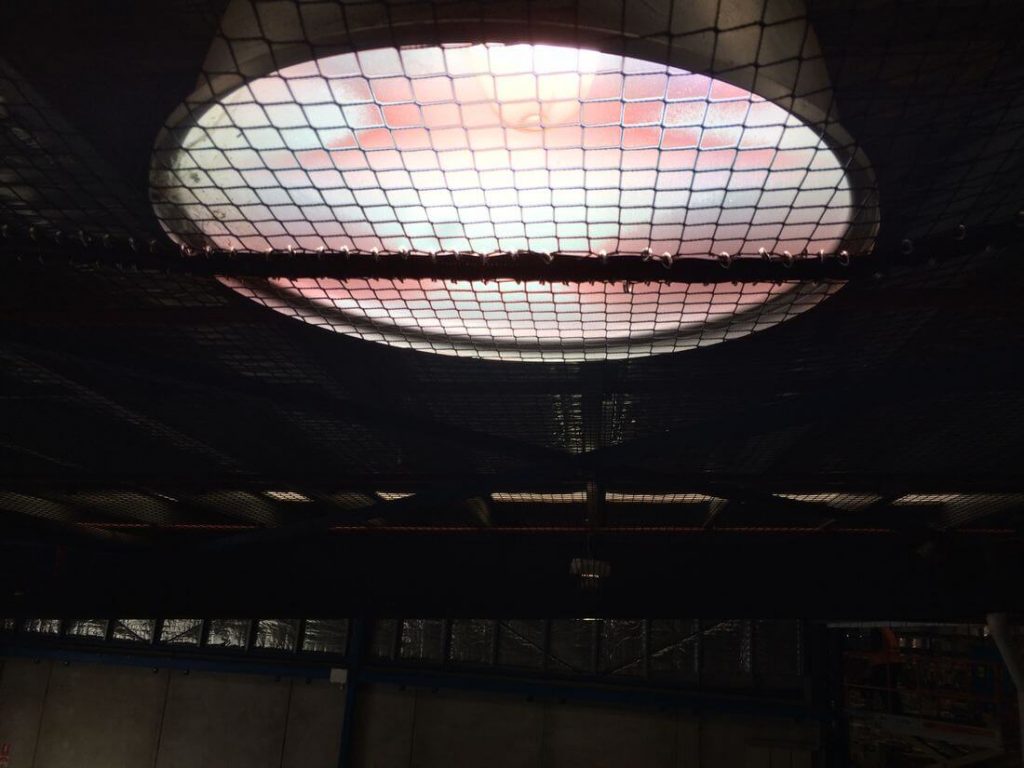 Bird netting under a round skylight inside a large building
